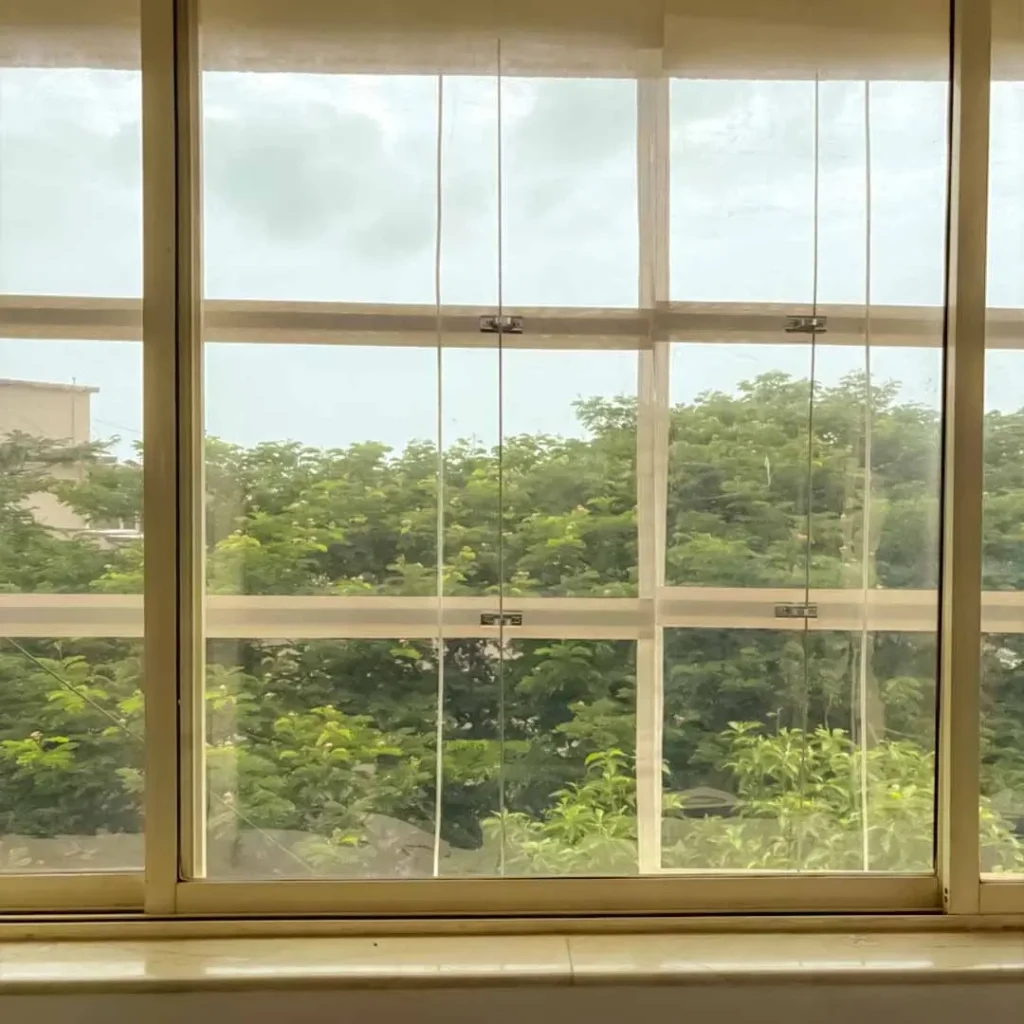 Monsoon blinds installation at gallery window in Panjim by S.N Interiors Goa