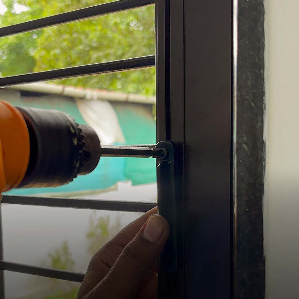 Mosquito mesh window drilling installation at Ribandar by Salman Azam, SN Interiors Goa