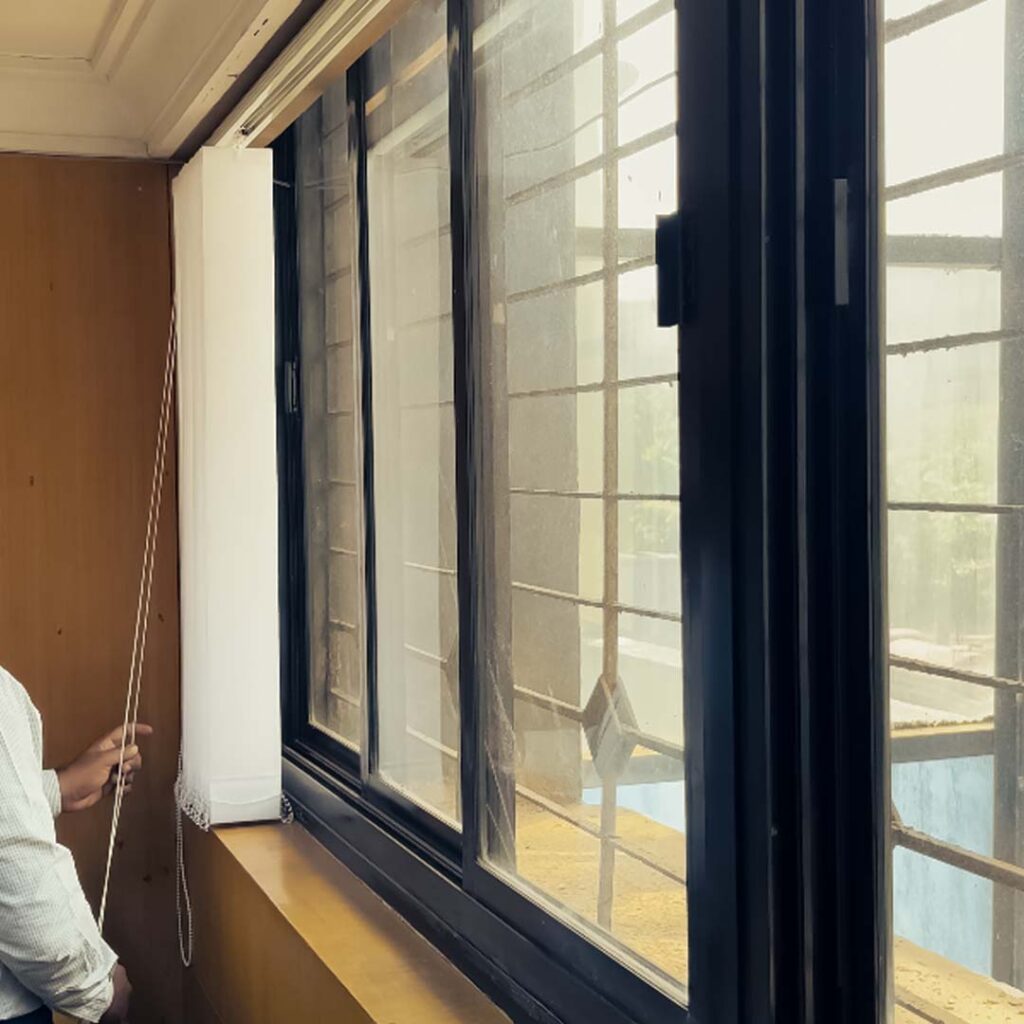 Installed vertical blinds on window at GIDC Goa by S.N Interiors.
