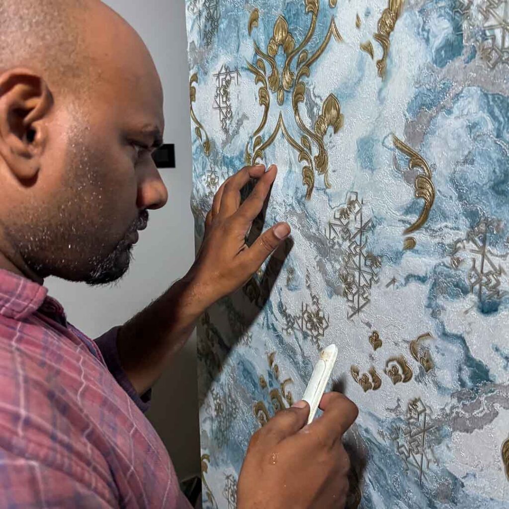 Wallpaper installation process at a residence in Ribandar, Goa