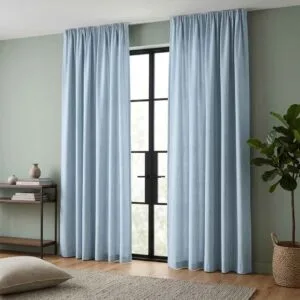 Solid sky blue linen curtains from the Malta collection installed by SN Interiors Goa.