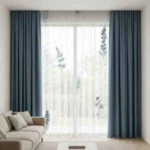 Premium slate blue blackout curtains and botanical sprig sheers professionally installed by SN Interiors Goa.