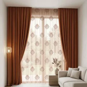 Premium terracotta-colored blackout curtains and damask patterned sheers installed by SN Interiors Goa.
