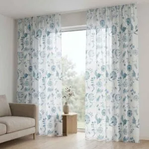 Premium white sheers with teal floral embroidery professionally installed by SN Interiors Goa in a modern living space.