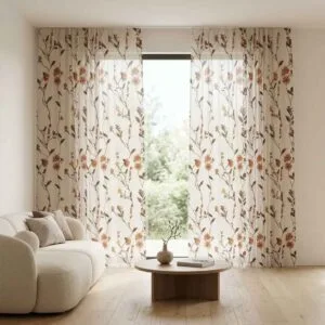 Designer off-white sheer curtains with warm orange floral embroidery installed by SN Interiors Goa in a modern minimalist room.