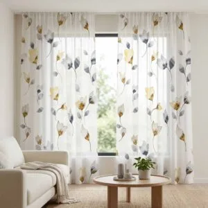 Designer white sheer curtains featuring yellow and grey floral patterns, professionally installed by SN Interiors Goa in a bright modern room.