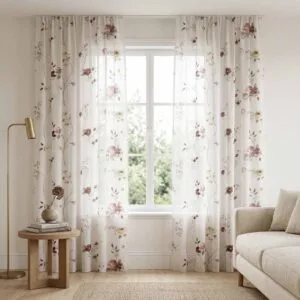 Elegant white sheer curtains with pink rose floral patterns professionally installed by SN Interiors Goa
